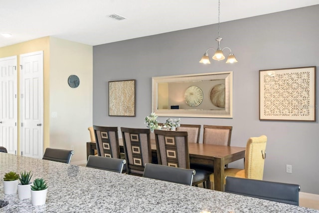 dining space featuring a chandelier