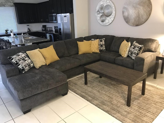 living room featuring light tile patterned flooring and sink