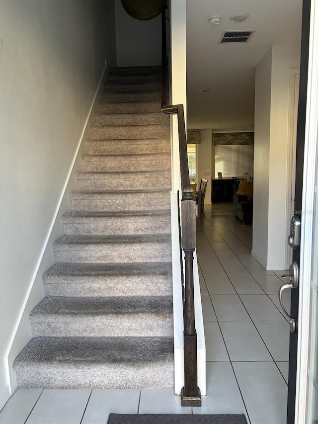 stairs featuring tile patterned flooring