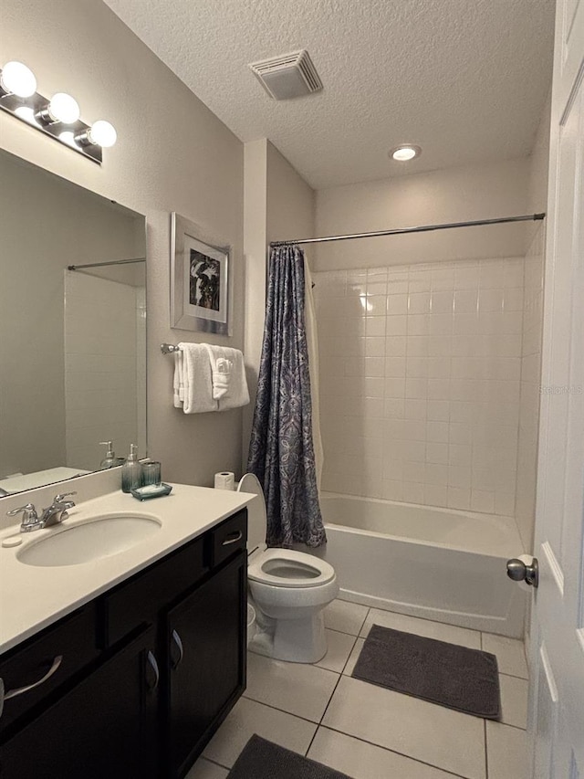 full bathroom with a textured ceiling, shower / bathtub combination with curtain, tile patterned floors, vanity, and toilet