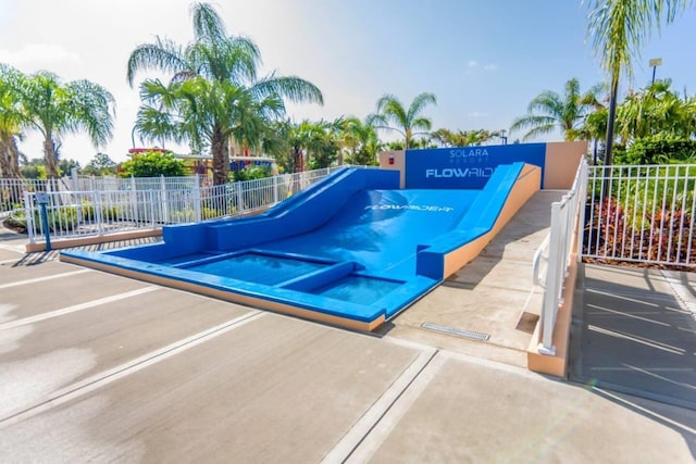 view of swimming pool featuring an in ground hot tub