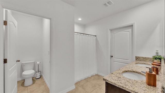 bathroom with walk in shower, vanity, toilet, and tile patterned flooring