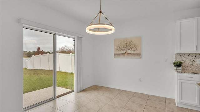 unfurnished dining area with light tile patterned floors