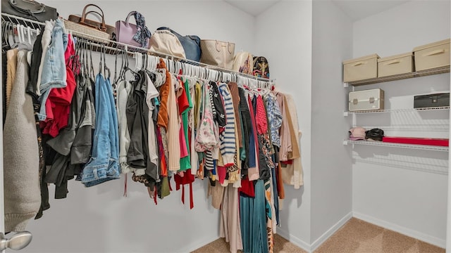 walk in closet featuring light colored carpet