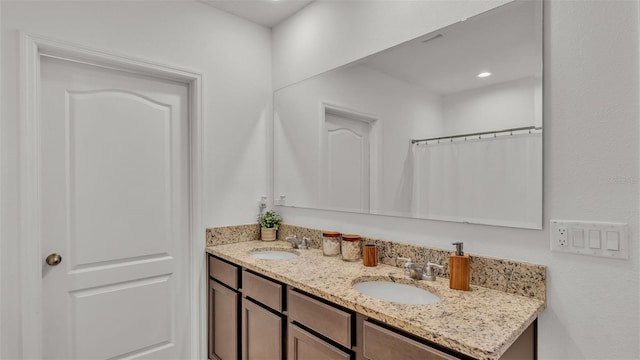 bathroom featuring vanity and a shower with shower curtain