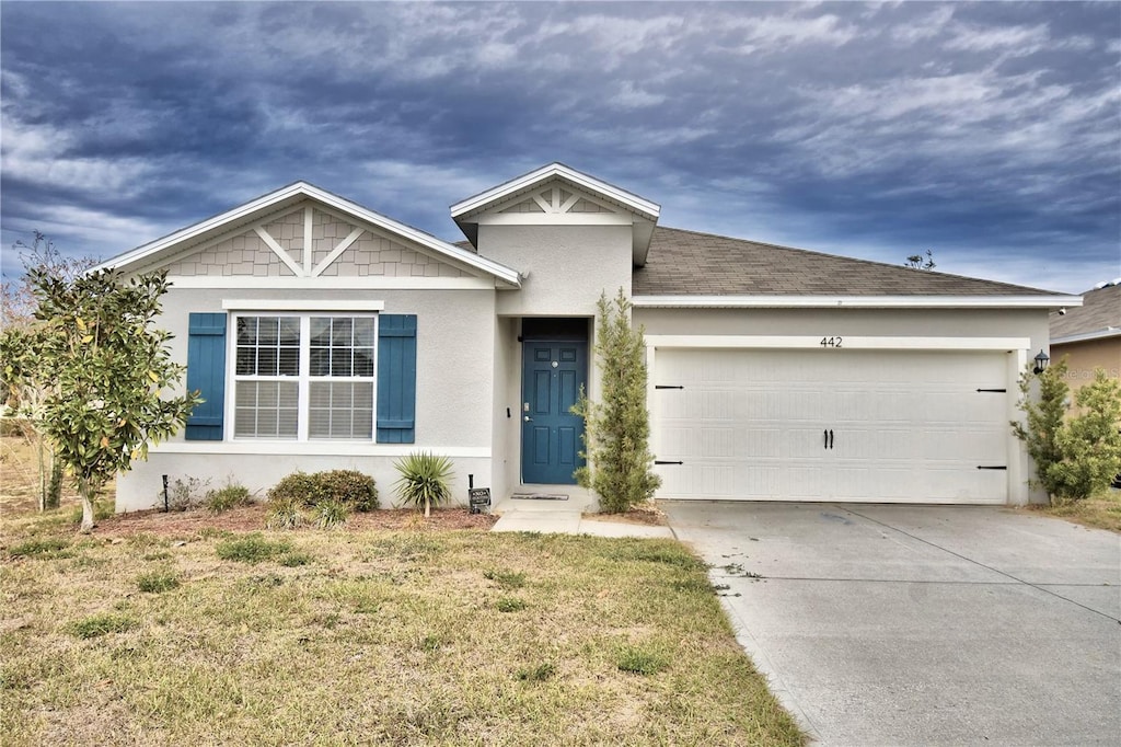 view of front facade with a garage and a front yard