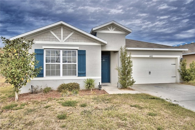 view of front facade featuring a garage and a front lawn