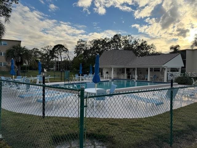 view of pool with a lawn and a patio area