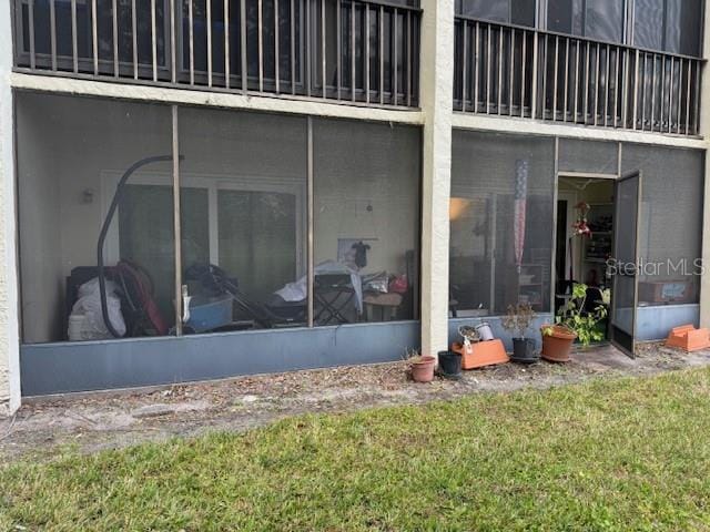 back of property with a lawn
