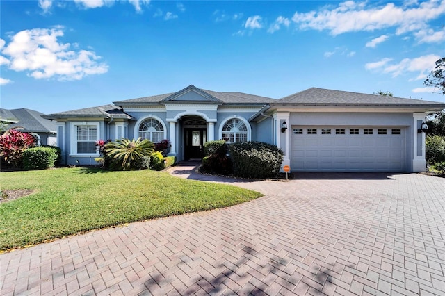 ranch-style house with a front yard and a garage