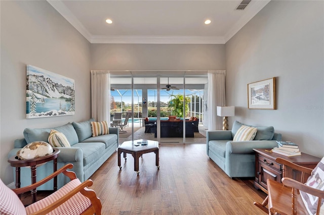 living room featuring crown molding and light wood-type flooring