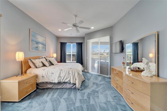 bedroom featuring dark carpet, ceiling fan, and access to outside