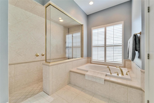 bathroom with shower with separate bathtub and tile patterned flooring