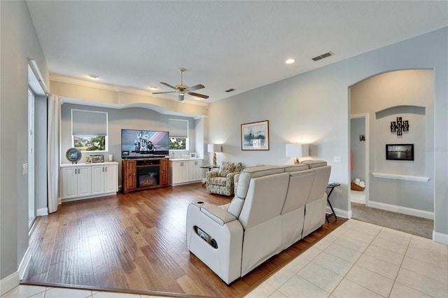 living room with light wood-type flooring and ceiling fan