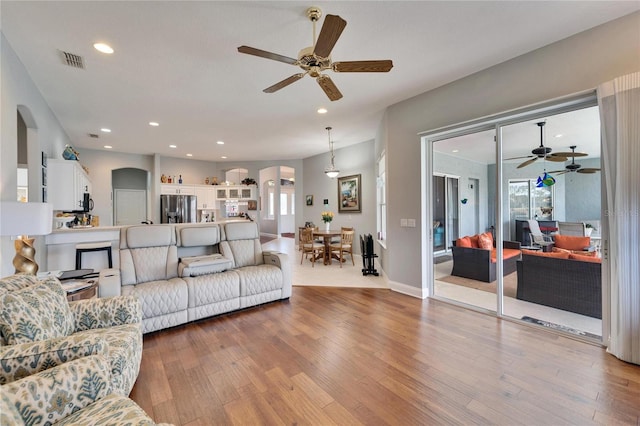 living room with ceiling fan and wood-type flooring