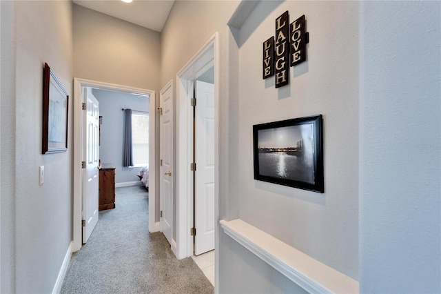 corridor with light colored carpet