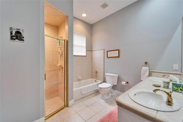 full bathroom featuring vanity, toilet, shower with separate bathtub, and tile patterned flooring