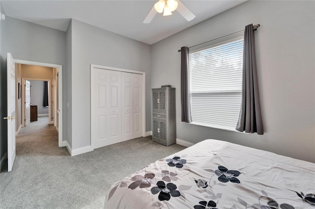 bedroom featuring a closet, ceiling fan, and light carpet