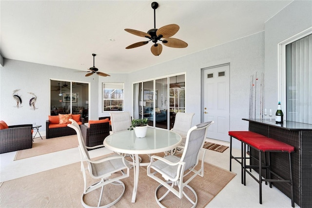 view of patio with an outdoor living space and ceiling fan