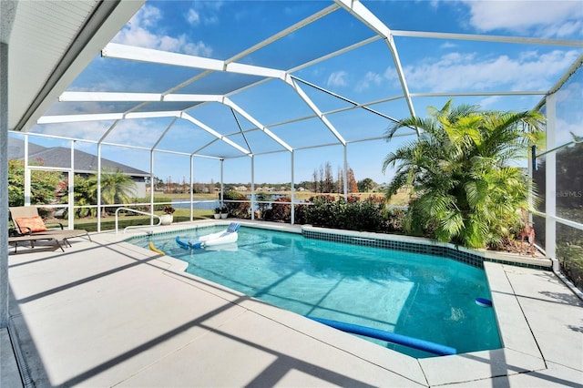 view of pool featuring glass enclosure and a patio