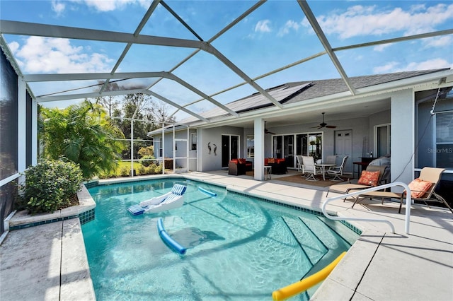 view of pool featuring ceiling fan, a patio, a lanai, and an outdoor hangout area