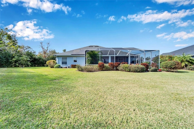 back of house with a lanai and a lawn