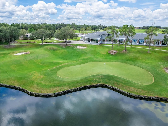 surrounding community with a yard and a water view