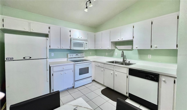 kitchen featuring sink, white cabinets, and white appliances