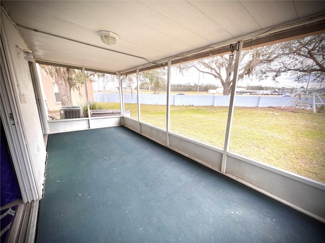 unfurnished sunroom featuring a water view