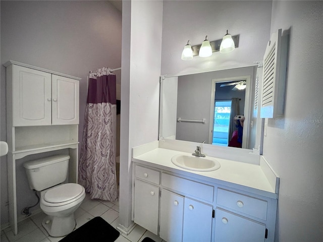 bathroom with curtained shower, tile patterned flooring, vanity, toilet, and ceiling fan