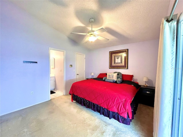 carpeted bedroom featuring ceiling fan, ensuite bath, a textured ceiling, and lofted ceiling