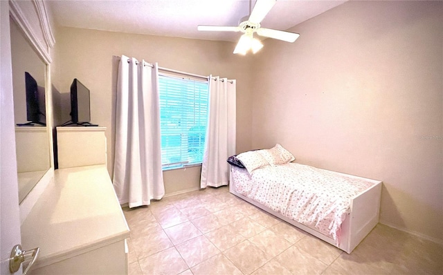 tiled bedroom with ceiling fan and vaulted ceiling