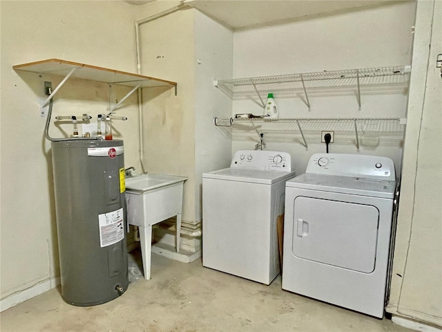 laundry room featuring electric water heater, washer and clothes dryer, and sink