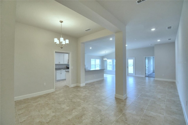 unfurnished room featuring a notable chandelier