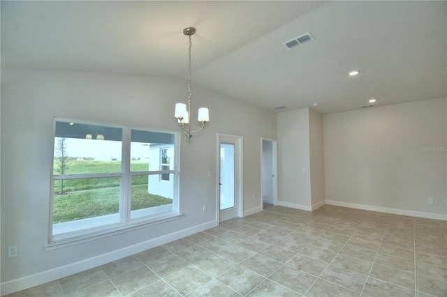 spare room with lofted ceiling and a chandelier