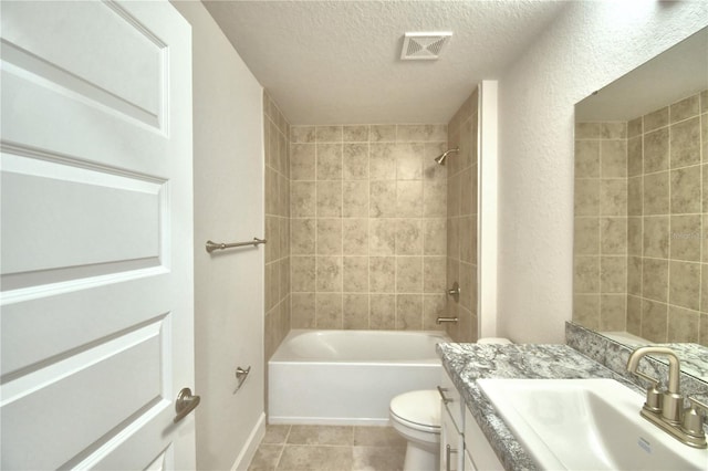 full bathroom with toilet, vanity, tile patterned flooring, tiled shower / bath combo, and a textured ceiling