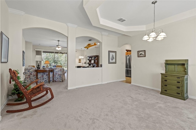 unfurnished room with ceiling fan with notable chandelier, a raised ceiling, and carpet