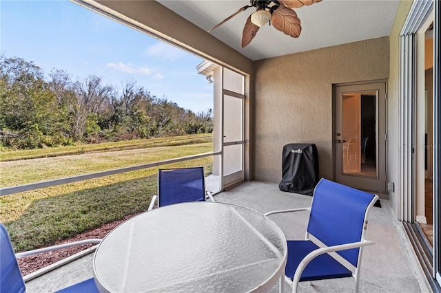 sunroom featuring ceiling fan