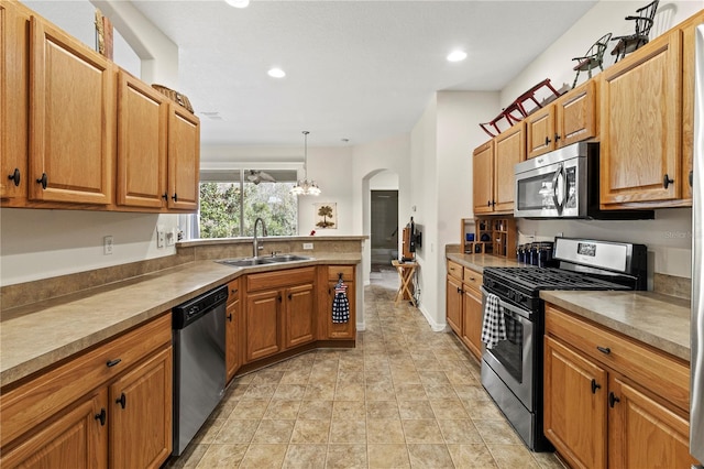 kitchen featuring pendant lighting, sink, and appliances with stainless steel finishes