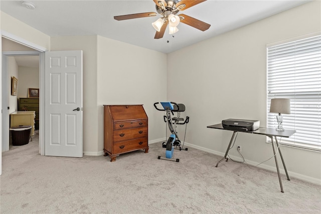 exercise room featuring ceiling fan and light colored carpet