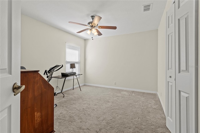 home office with light carpet and ceiling fan