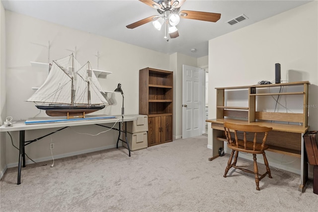 home office with ceiling fan and light carpet