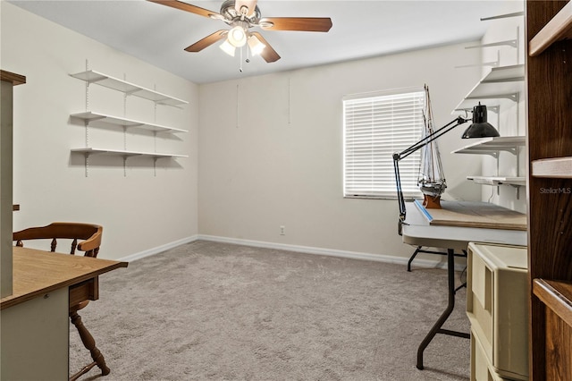 carpeted office space featuring ceiling fan