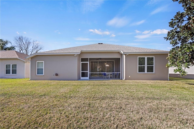 rear view of property with a yard