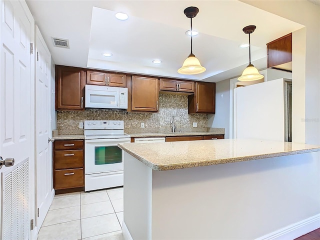 kitchen with tasteful backsplash, white appliances, light tile patterned flooring, pendant lighting, and light stone counters