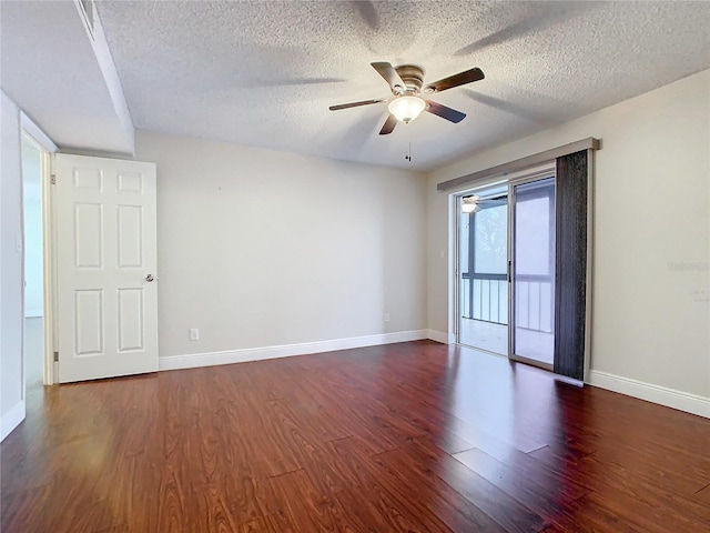 spare room featuring a textured ceiling, dark wood-type flooring, and ceiling fan