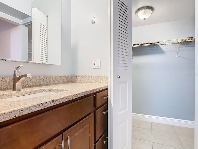 bathroom with tile patterned floors and vanity