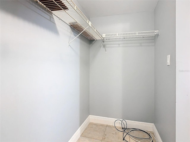 spacious closet with light tile patterned flooring