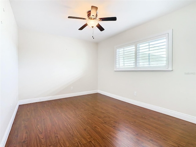 spare room featuring ceiling fan and dark hardwood / wood-style floors