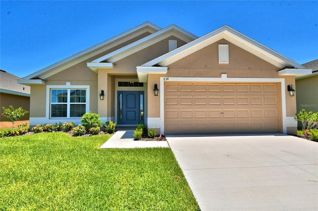 view of front of property with a garage and a front yard